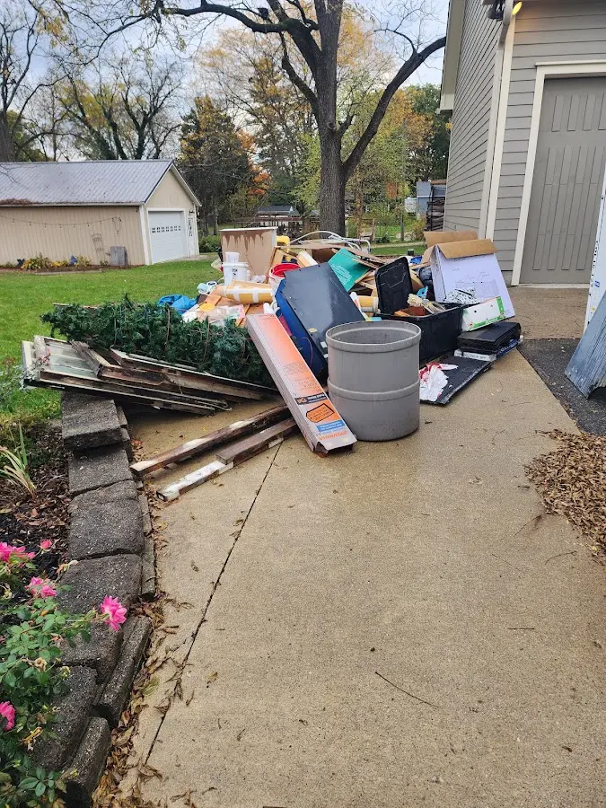 Dumpster being loaded with debris for Estate Cleanout Dumpster Rental in Ashville